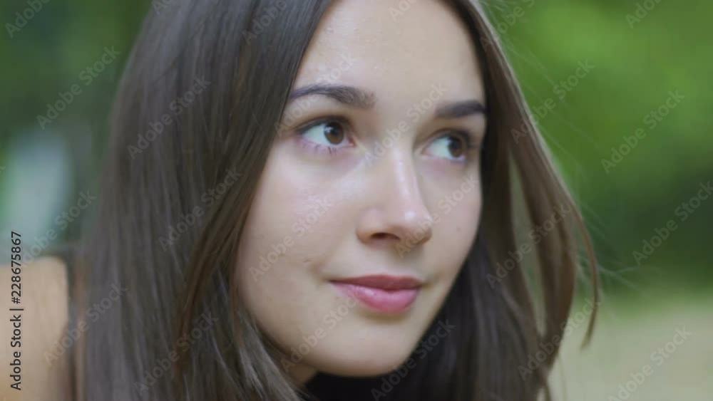 Serious devoted look of brunette woman looking up outdoors, confident female Serious devoted look of brunette woman looking up outdoors, confident female
