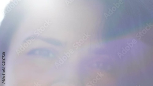 Playful eyes woman in bright divine sun rays, child's memory of mother childhood