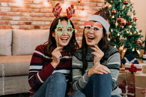 two friends celebrating Christmas at home photo