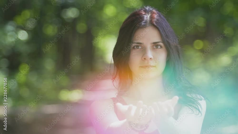 Beautiful woman shares bright light in hands, wisdom concept, religious sign Beautiful woman shares bright light in hands, wisdom concept, religious sign