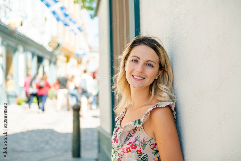 Fashion woman portrait of young pretty trendy girl posing on the quebec city street Fashion woman portrait of young pretty trendy girl posing on the quebec city street