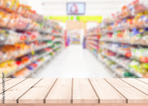 Wood table or wood floor with supermarket blur background for Product display