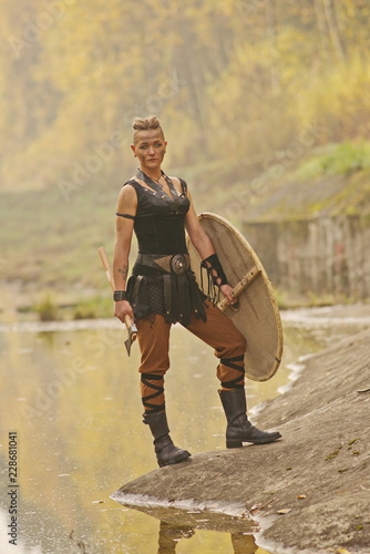 Canvas Print Viking woman with axe in a traditional warrior clothes