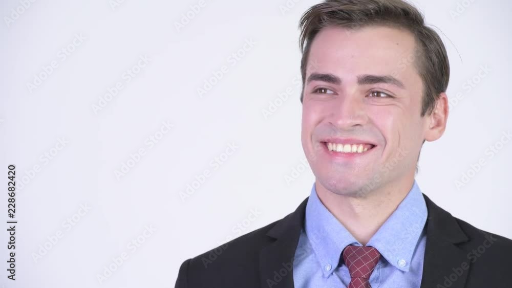 Young happy handsome businessman smiling while thinking