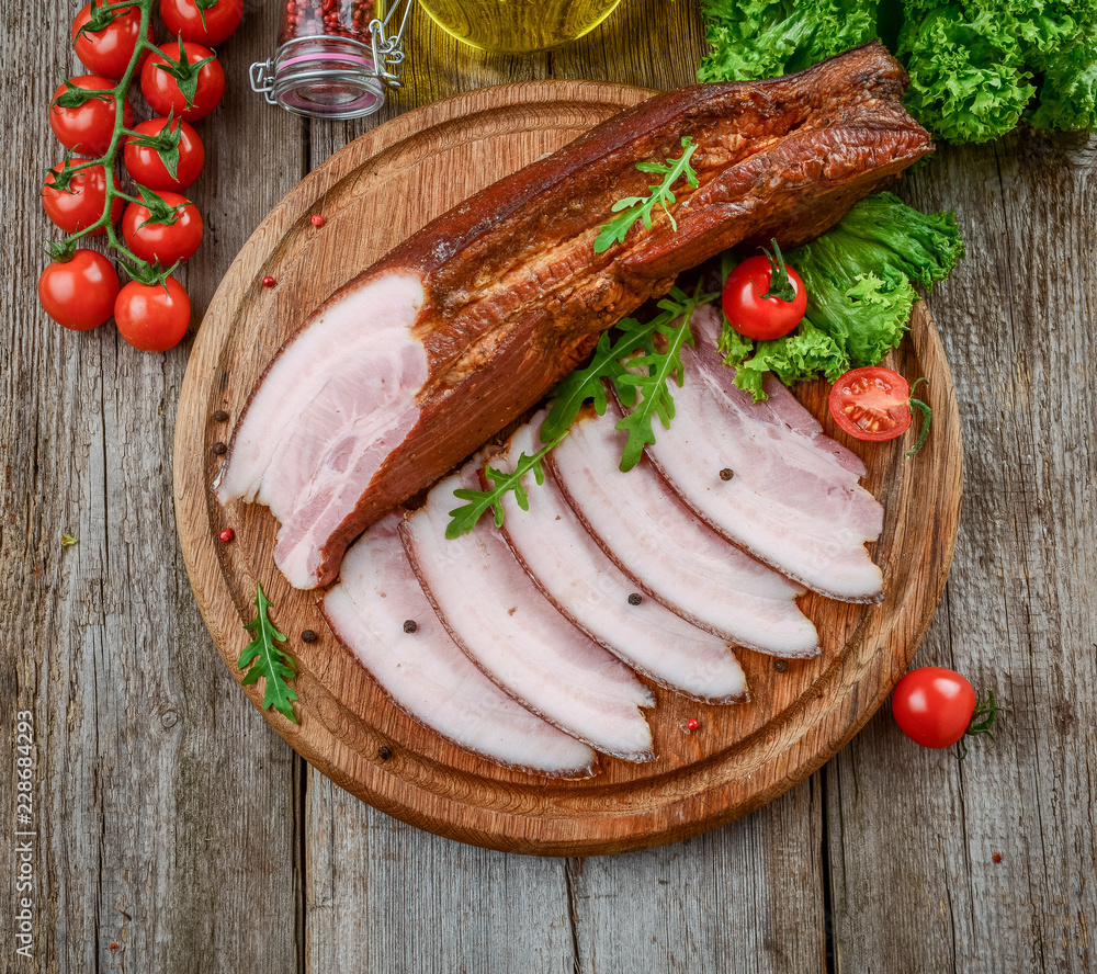 Slices of bacon on the wooden background. Slices of bacon on the wooden background.
