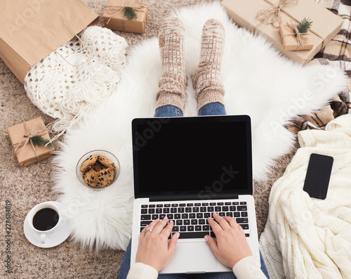 Preparing for Christmas. Woman buying presents on laptop, copy space