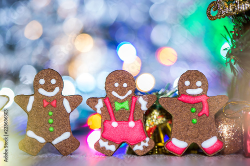 Cute gingerbread man with christmas tree and blurry sparkle background  close up  bokeh  text space copy space 