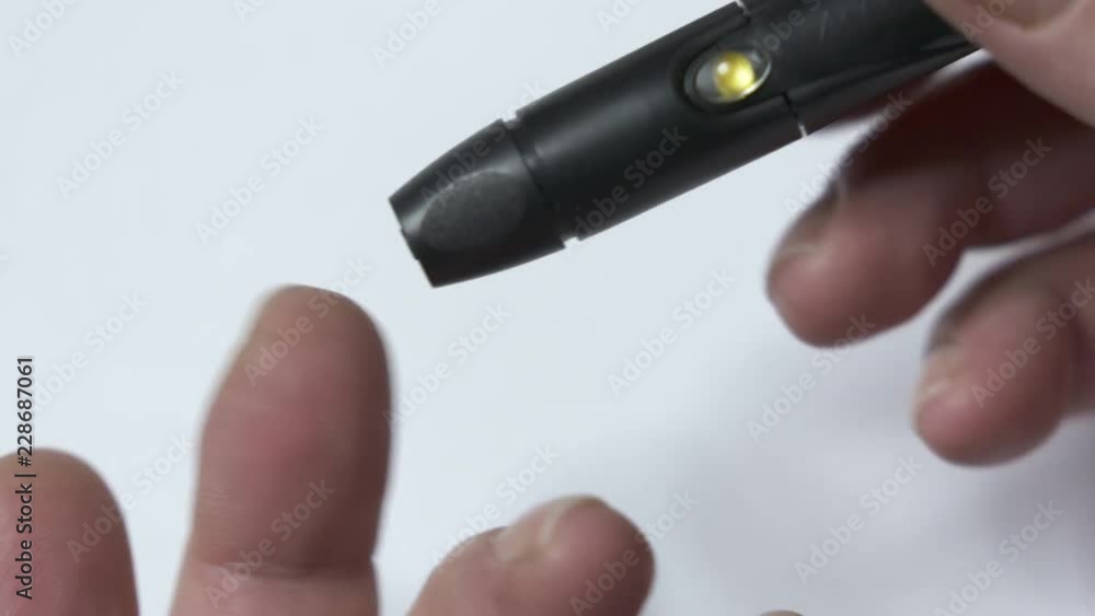 Patient with diabetes using a blood glucose meter to test blood glucose