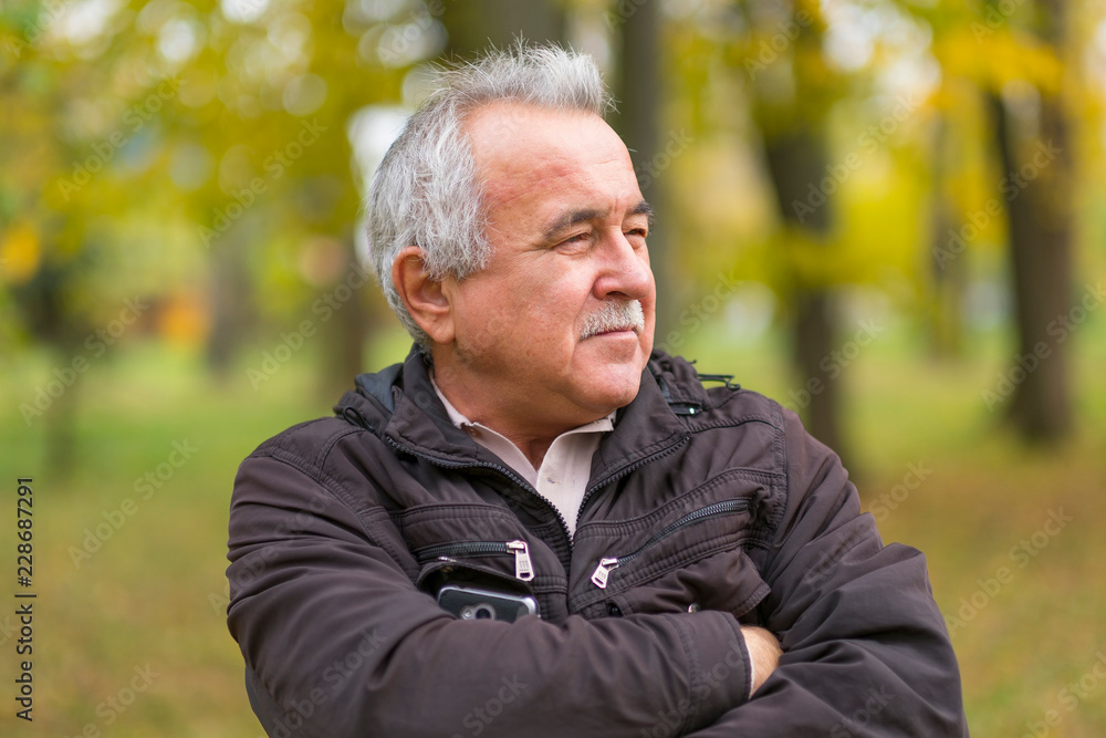Portrait of an elderly man in the park. Portrait of an elderly man in the park.