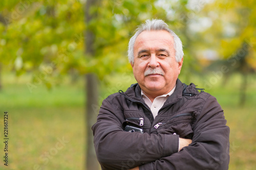 Portrait of an elderly man in the park.
