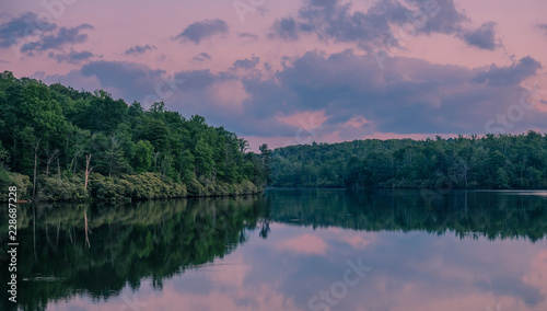 Fototapeta Naklejka Na Ścianę i Meble -  Julian Price Memorial Park, North Carolina, USA - June 14, 2018: Sunset at a lake in Julian Price Memorial Park National Park