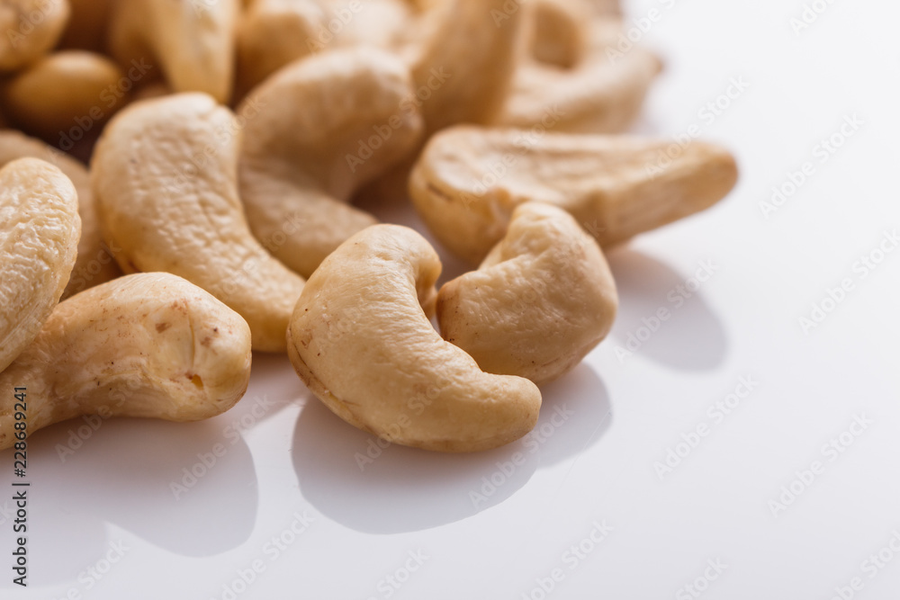 cashew nuts on a white acrylic background cashew nuts on a white acrylic background