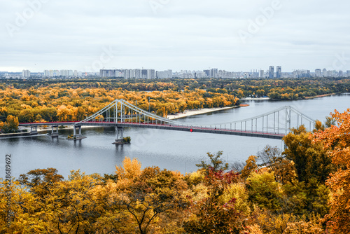 Golden autumn in Kiev, Ukraine. View on footbridge, river Dnieper and Trukhanov Island in Kyiv.