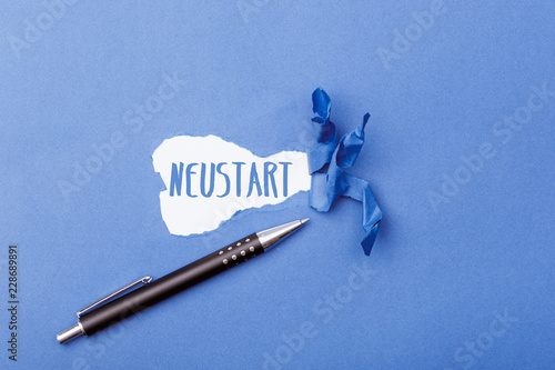 German word for new start on ripped paper