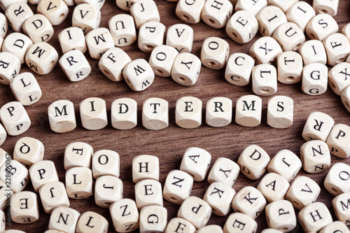 Midterms word on dice letters in chaos table photo