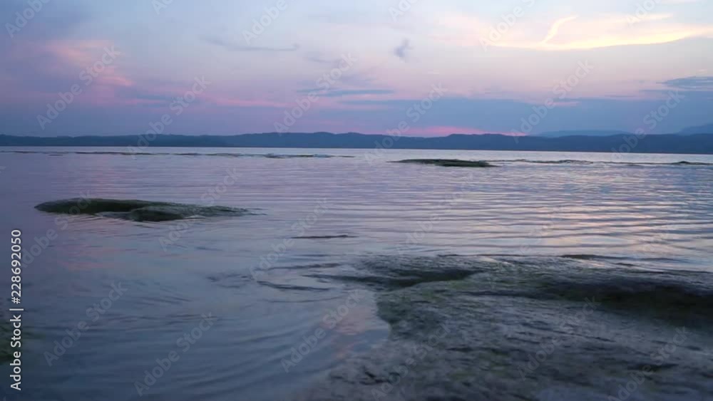 sun is setting down at a very calm sea, taken at low angle sun is setting down at a very calm sea, taken at low angle