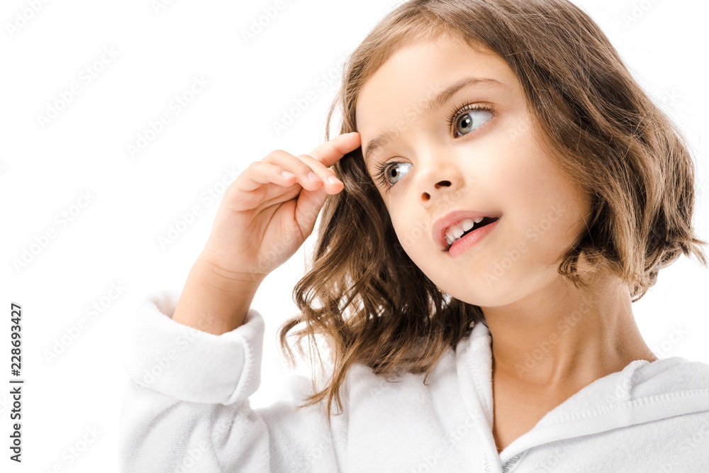 Naklejka premium portrait of adorable child in white bathrobe looking away isolated on white