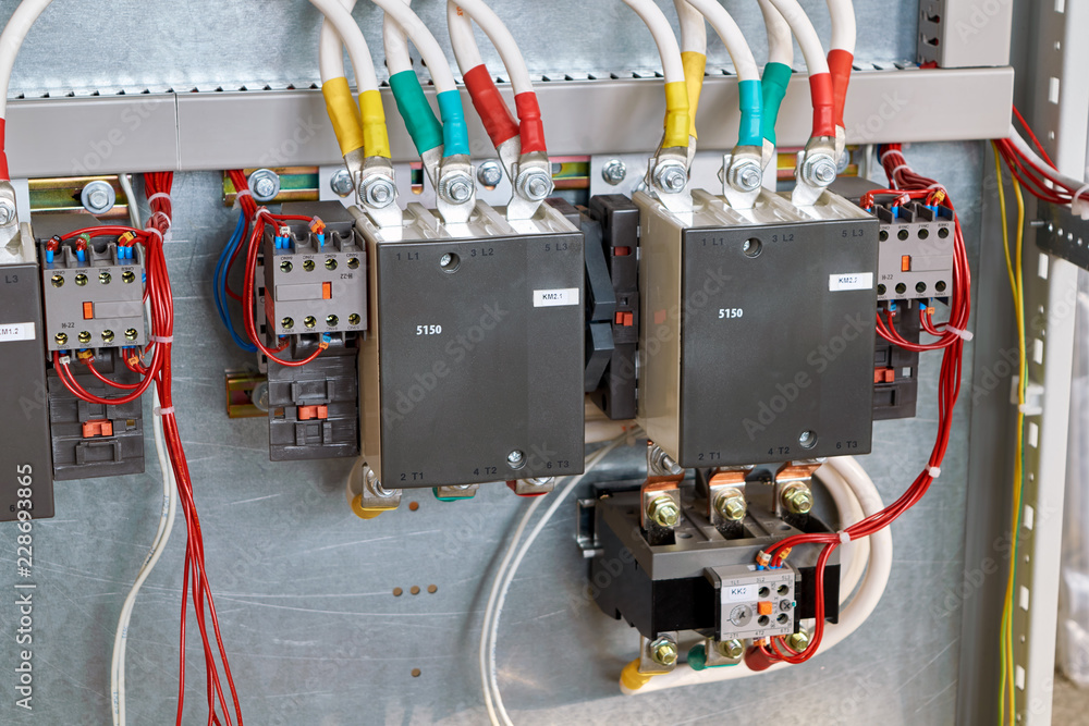 Two magnetic starters are installed in the large electrical Cabinet. Additional contacts are fixed on the side of the contactors. A thermal relay is attached at the bottom. Two magnetic starters are installed in the large electrical Cabinet. Additional contacts are fixed on the side of the contactors. A thermal relay is attached at the bottom.