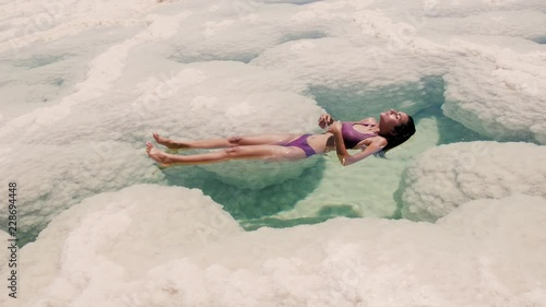 beautiful woman floting at the Dead Sea photo