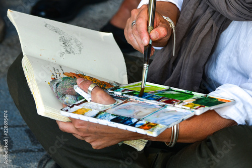 Hands Creation picture abstract of watercolor painting with brush in Art subject outside classroom  in France
