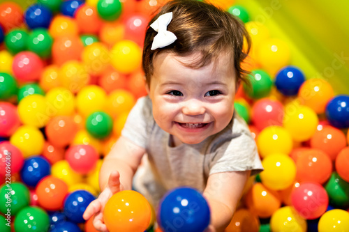 Portrait of a adorable infant on colorful balls