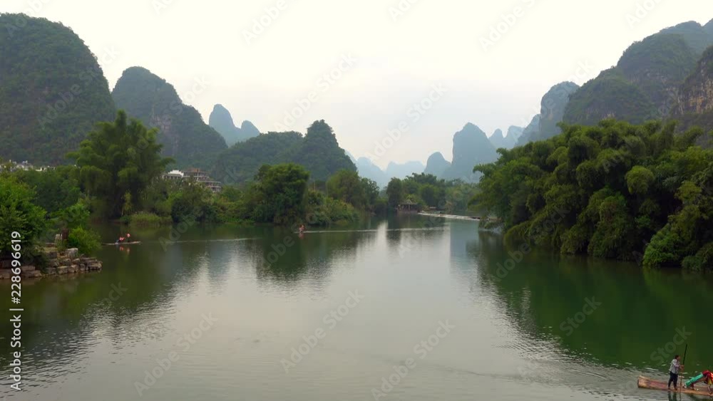 Fisherman, Karst mountains and limestone peaks of Yulong River, Yangshuo, Guilin, China Fisherman, Karst mountains and limestone peaks of Yulong River, Yangshuo, Guilin, China