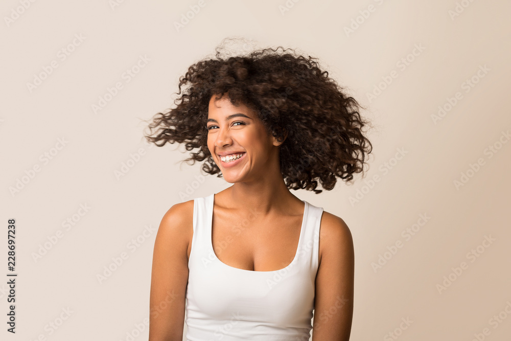 Fototapeta premium African-american woman fooling with her curly hair
