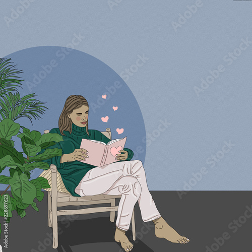 Young woman reading book while sitting on chair at home