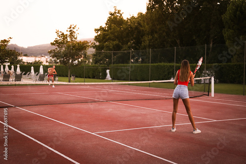 Couple playing tennis at the court
