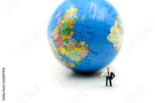 Miniature people   Businessman standing with Global World map balloon Success Business Due around the world and Strategy Planning concepts.