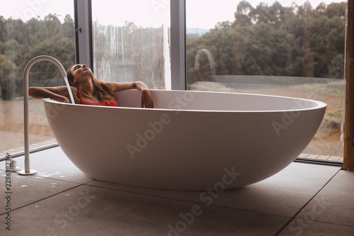 Woman in a modern bath tub
