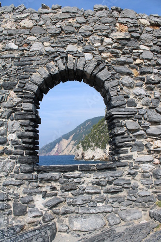 Finestra arcata mura in pietra con vista mare