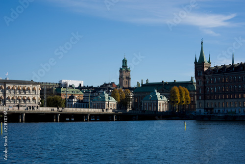 Stockholm water front with landmarks  boats an autumn day with blu sky and sea  orange and red leafs.