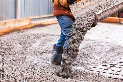 Closeup shot of concrete casting on reinforcing metal bars of floor in industrial construction site © Nobilior