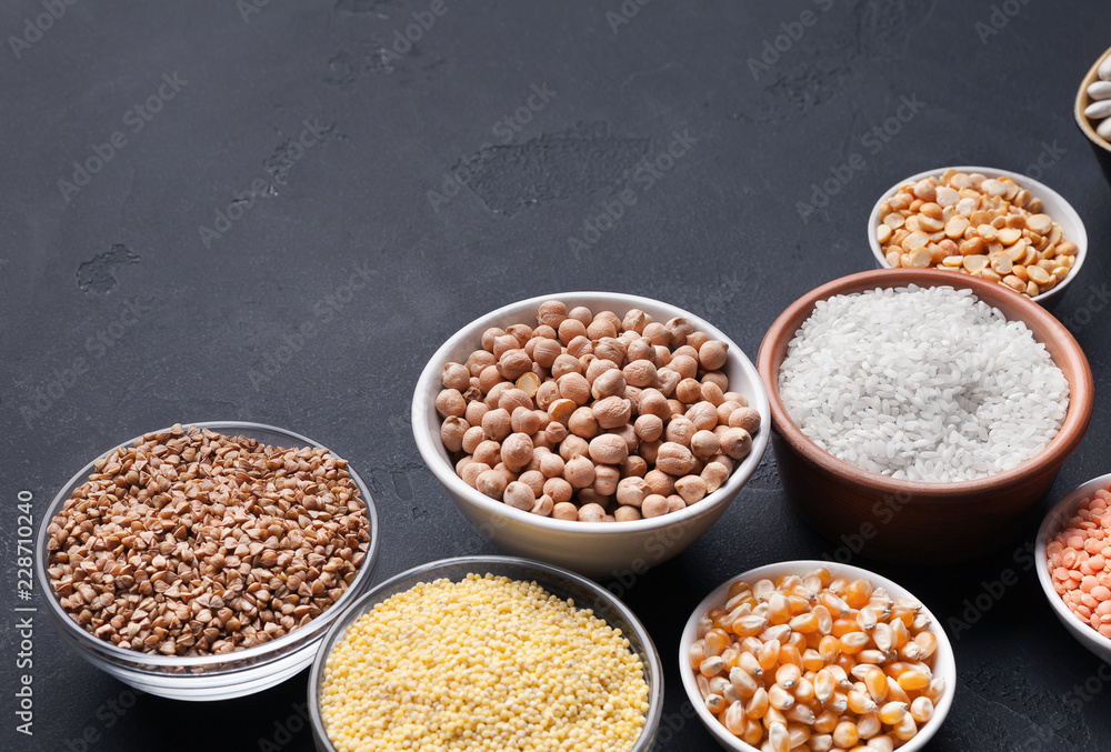 Grains assortment in bowls on dark background Grains assortment in bowls on dark background