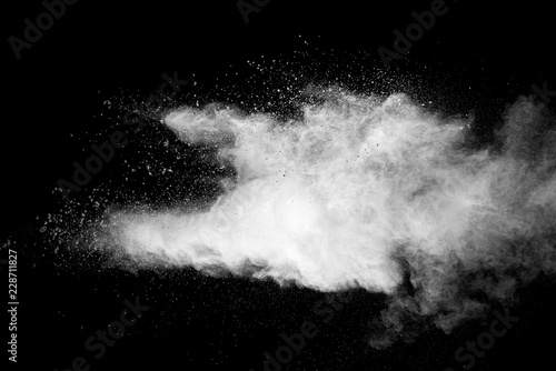 Explosion of white dust on black background.