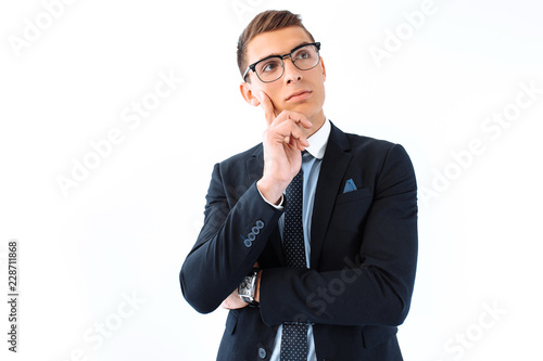 Brooding business man in glasses and suit isolated on white background © Shopping King Louie