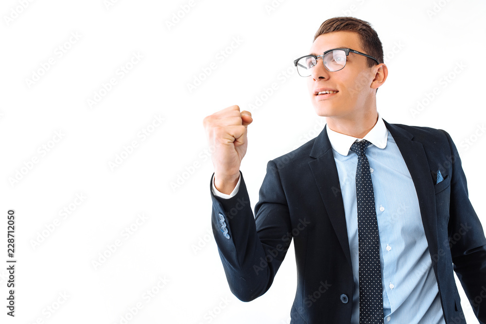 happy businessman in glasses and suit shows a gesture of success and victory, on a white background happy businessman in glasses and suit shows a gesture of success and victory, on a white background