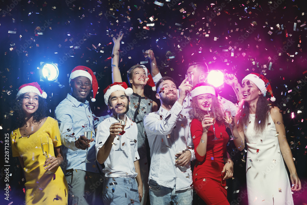 Fotografie Group of friends enjoying party with confetti