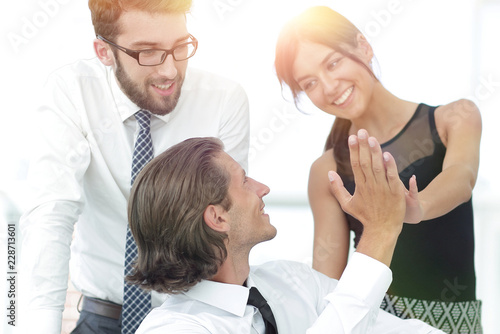 Young business colleagues giving each other a high five