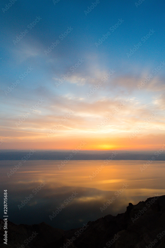 Dead Sea, Jordan. 6th June 2015. Dramatic skies reflect off the Dead Sea during sunset from a panoramic viewpoint near the town of Madaba.