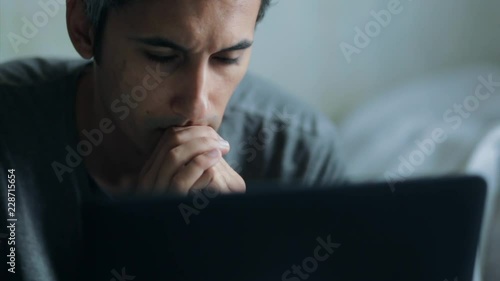 anxious man looking at laptop display