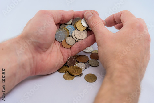 Studio photo of hands with cash coins on white background