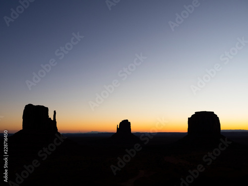 Monument Valley, Utah, USA. Monument Valley silhouetted against the rising sun. © Dave