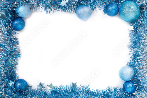 Blue christmas balls with blue tinsel on white background. New year frame. Isolated on white. New year 2019