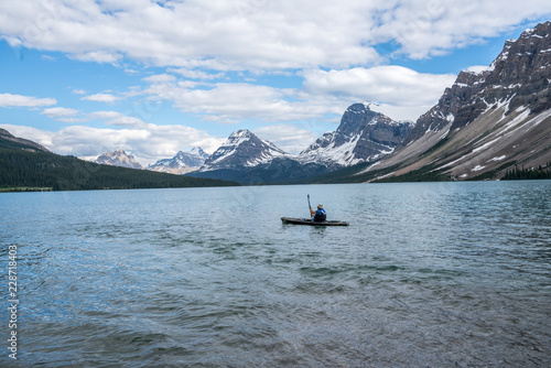 Man Kayaking on Banff Lake  © James