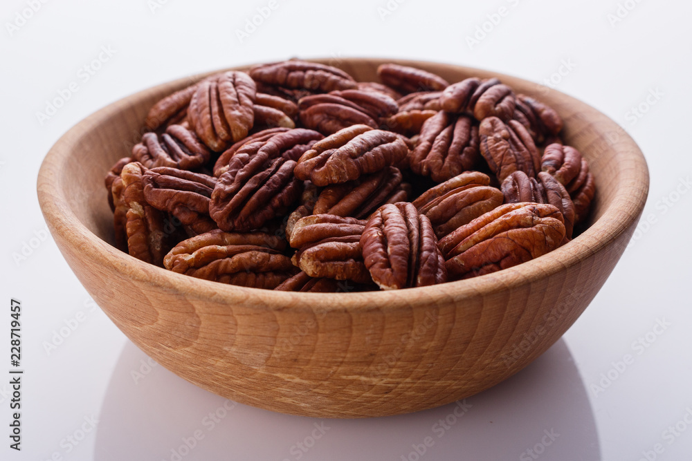 delicious pecan nuts on a white acrylic background delicious pecan nuts on a white acrylic background
