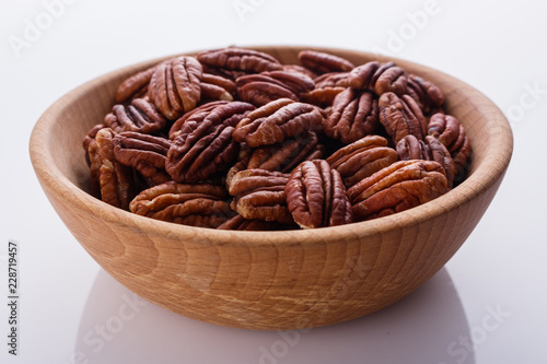 delicious pecan nuts on a white acrylic background