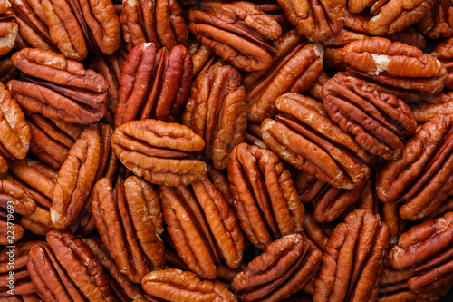 delicious pecan nuts on a dark stone background