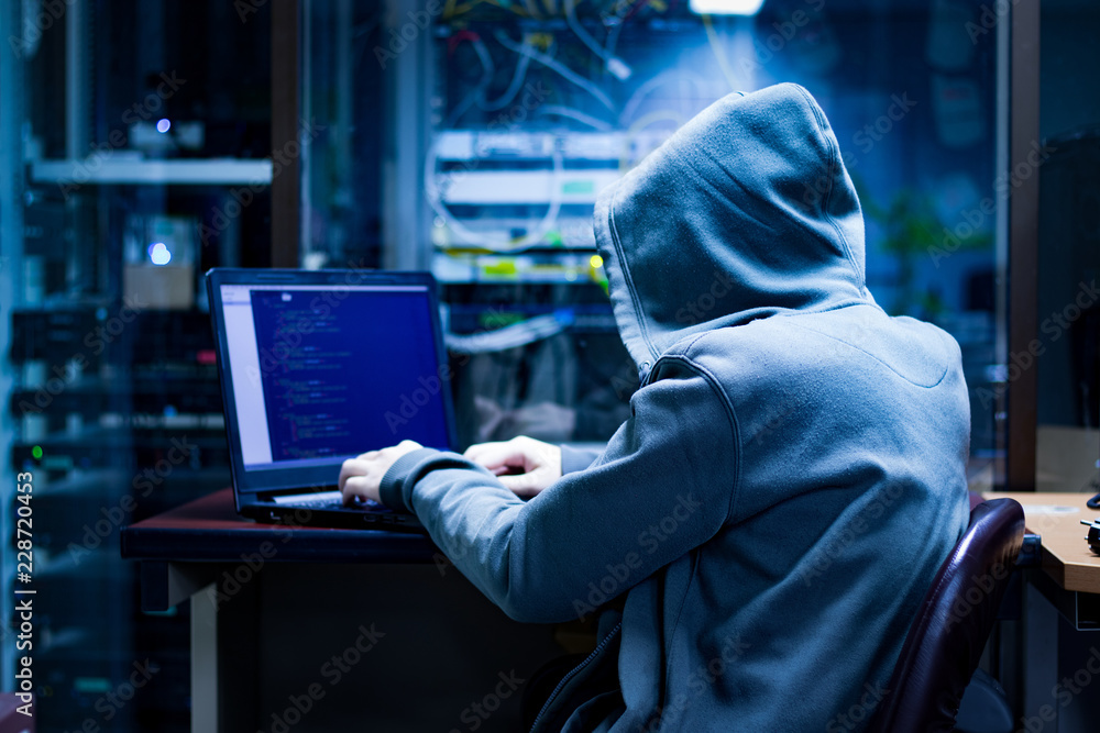 Dangerous Hooded Hacker Breaks into Government Data Servers and Infects Their System with a Virus. His Hideout Place has Dark Atmosphere Dangerous Hooded Hacker Breaks into Government Data Servers and Infects Their System with a Virus. His Hideout Place has Dark Atmosphere